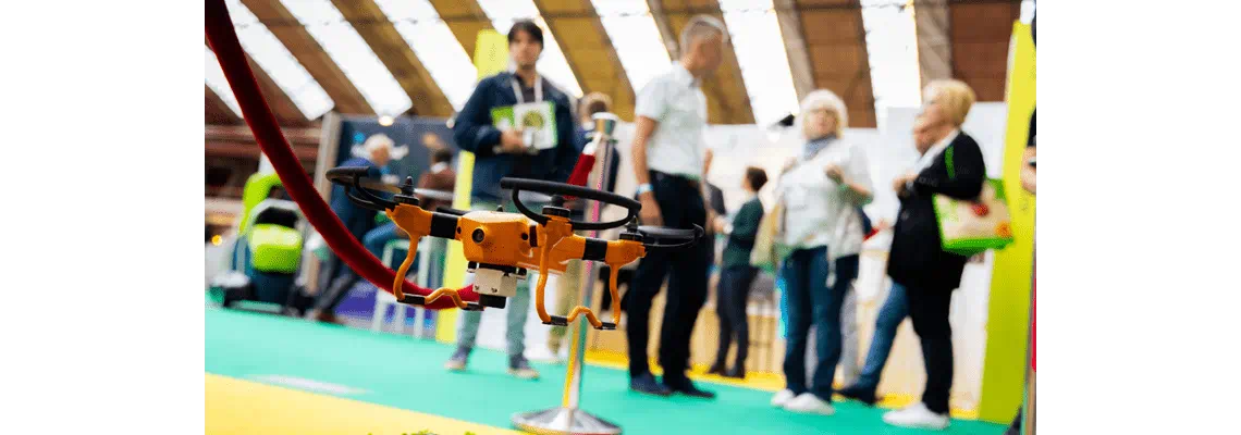an orange drone with people in the background